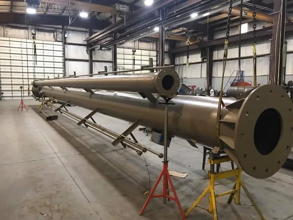Large fabricated flare stack components in a workshop